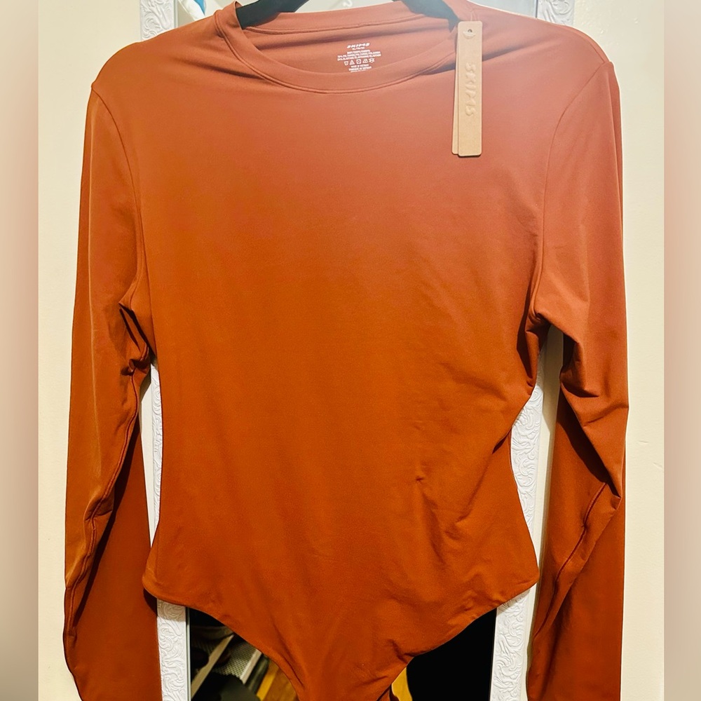 SKIMS Fits everybody long sleeve crew neck bodysuit, color saffron.